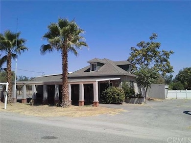 FRONT OF PROPERTY WITH  COVERED ENTRANCE AND CARPO