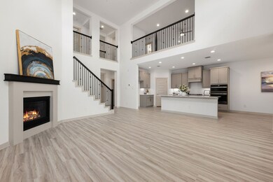 Soaring ceilings and a cozy fireplace create a war