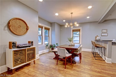 Dining space with an inviting chandelier and light hardwood / wood-style floors