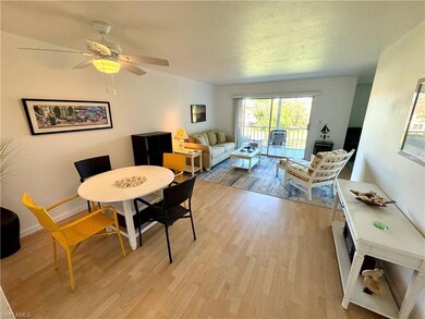 Dining area featuring light wood-style floors, a ceiling fan, and a textured ceiling