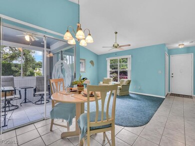 Carpeted dining room with a ceiling fan, tile patt