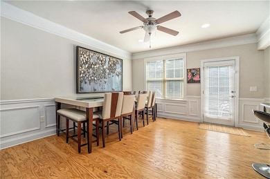 Dining area featuring a wainscoted wall, wood fini