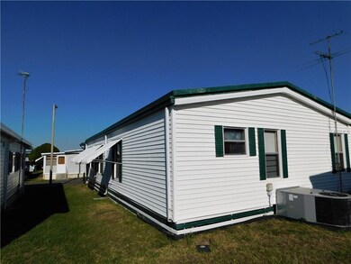 Newer AC unit and TV antenna on home.