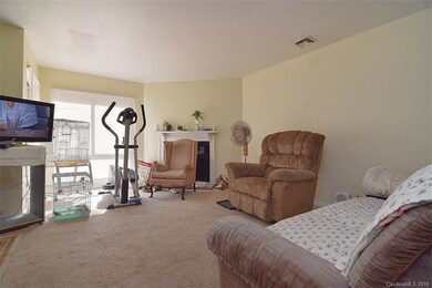 Great room accented with a wood burning fireplace.