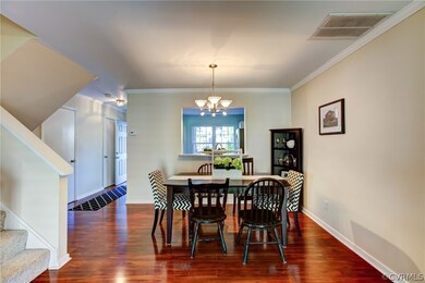 Dining area with chandelier and opening to kitchen