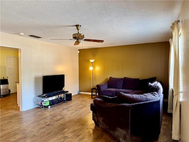 Living room with hardwood / wood-style floors, a t
