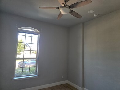 Unfurnished room featuring light wood-type flooring and ceiling fan
