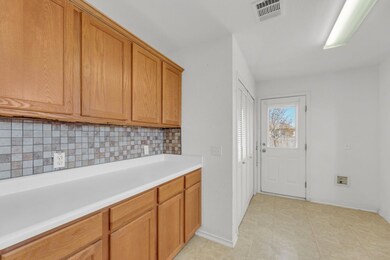 Laundry room featuring baseboards
