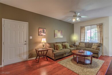 Living area featuring ceiling fan and wood finishe