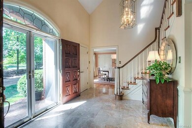 Welcoming foyer with double entry doors, marble fl