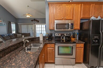 Kitchen with stainless steel appliances, sink, cei
