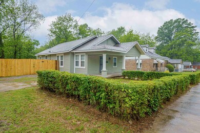 Bungalow with fence, a porch, and roof with shingles