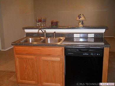 Other side of bar, features the kitchen sink and d