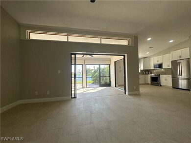 Unfurnished living room featuring vaulted ceiling