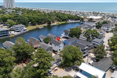 Aerial perspective of suburban area featuring a nearby body of water