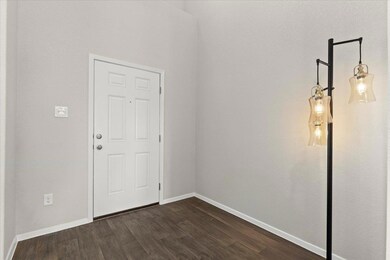 Spare room with dark wood-style flooring and base