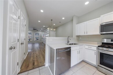 Kitchen with light countertops, appliances with st