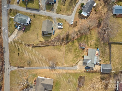 Drone view looking down towards entire lot.  Moody Ave located at left side of photo
