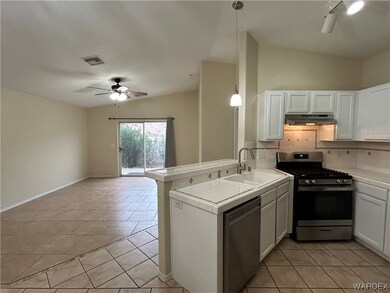 Kitchen featuring vaulted ceiling, stainless steel