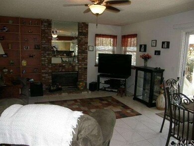Family room with fireplace, ceiling fan and slider