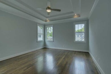Large master bedroom with coffered ceiling on the first floor and lots of natural light
