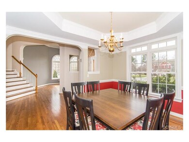 The spacious dining room has hardwood floors, trey