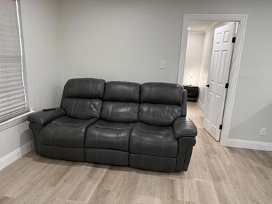 Living area with light wood finished floors and b