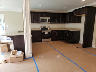 The kitchen has custom cabinets and granite tops.