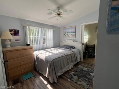 Bedroom with ceiling fan, wood-type flooring, and 