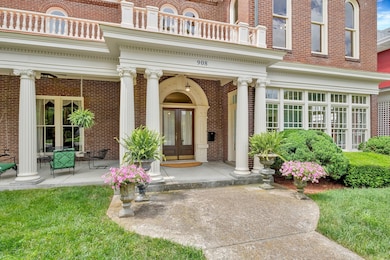 The stately original columns perfectly frame the sweeping front sitting porch and the entry with original double doors.