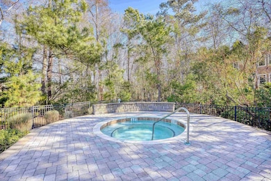 View of pool with a hot tub
