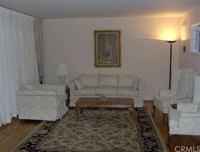 LIVING ROOM WITH SLIDING GLASS DOORS GOING TO ENCL