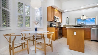 Kitchen with light stone countertops, appliances w