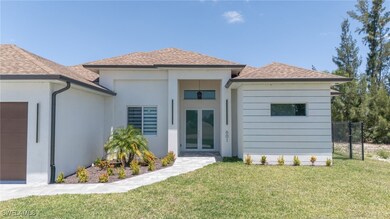 Rear view of property featuring a yard, stucco sid