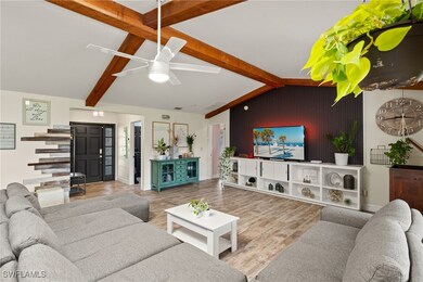 Living room featuring ceiling fan, wood-type floor