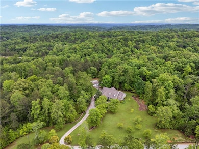 Birds eye view of property featuring a view of tre