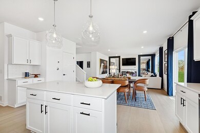 (Photo of an inventory home, actual homes finishes will vary) Soaked in natural sunlight, the homes eat-in dining room has ample space for a dining table.