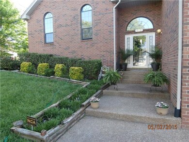 As you walk up to the front door, notice the walkway is surrounded by greenery