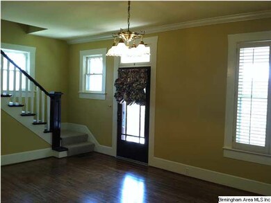 Living room has handsome windows with plantation s