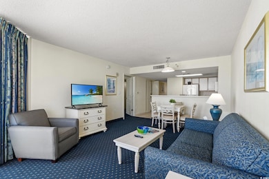Living area featuring visible vents, carpet, and a