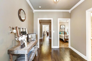 Foyer - Features include crown and corner molding and hardwood flooring.  The home has 9' smooth ceilings throughout.