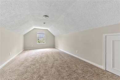 Additional living space featuring carpet floors, a