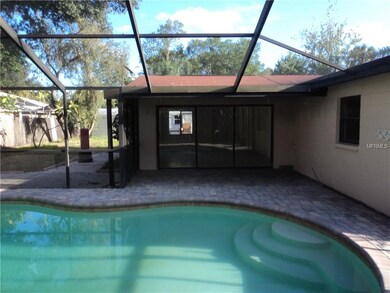 Covered porch, pavers inside the pool cage
