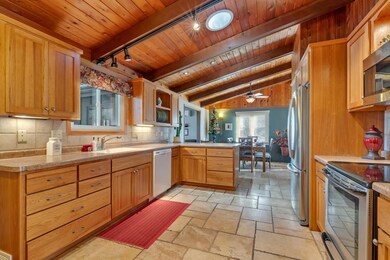 Kitchen with travertine flooring and Aspen cabinet