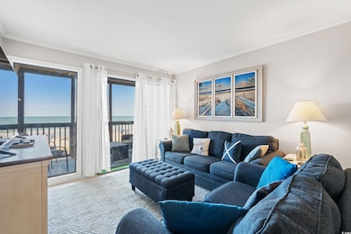 Tiled living room featuring crown molding and a water view