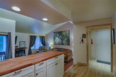 Kitchen featuring wood counters, open floor plan,