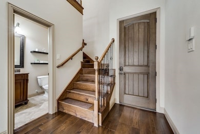 Staircase featuring wood finished floors and baseboards