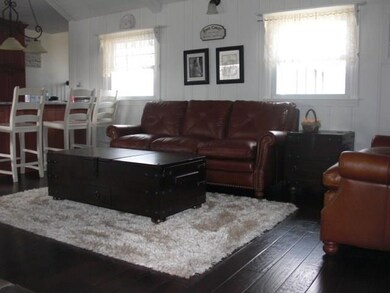 The living room that is separated from the kitchen