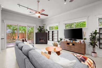 Living room featuring track lighting, a ceiling f