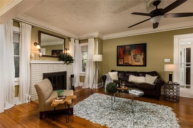 Living Room with Wood Burning Fireplace and Pictur